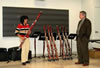Bassoonist Aura Trevino tries the latest models of Fox bassoons while Alan Fox, CEO of Fox Products, listens.